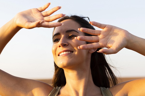 woman covering her face from sun